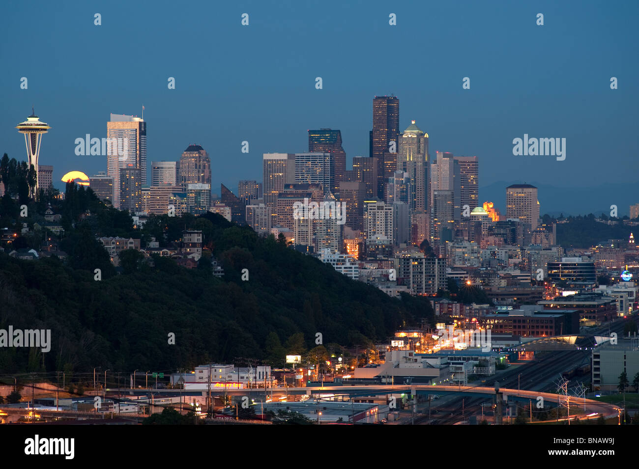 Retro Image of Seattle skyline with moon rising over city. Stock Photo