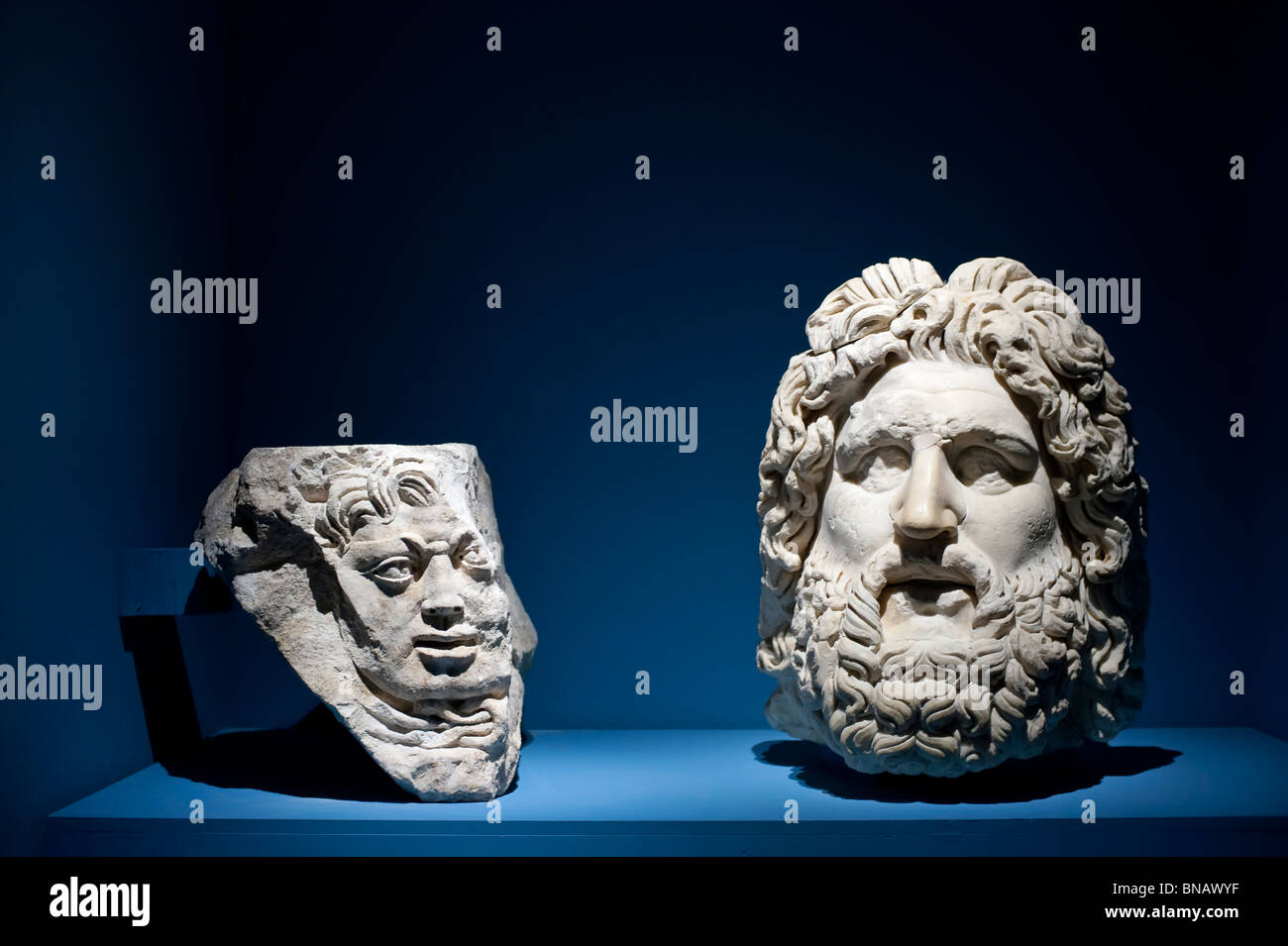 An architectural element with head of Medusa in stone and a head of Jupiter in marble at 'I due Imperi' exhibition Stock Photo