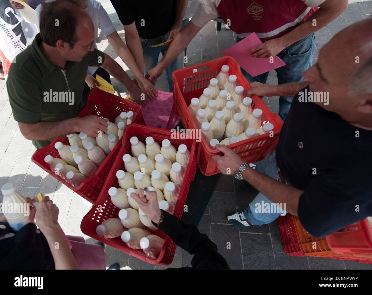 Distribution of bottles of milk during a protest of milk producers against the 'quotas' , Piazza San Babila Milan Italy Stock Photo