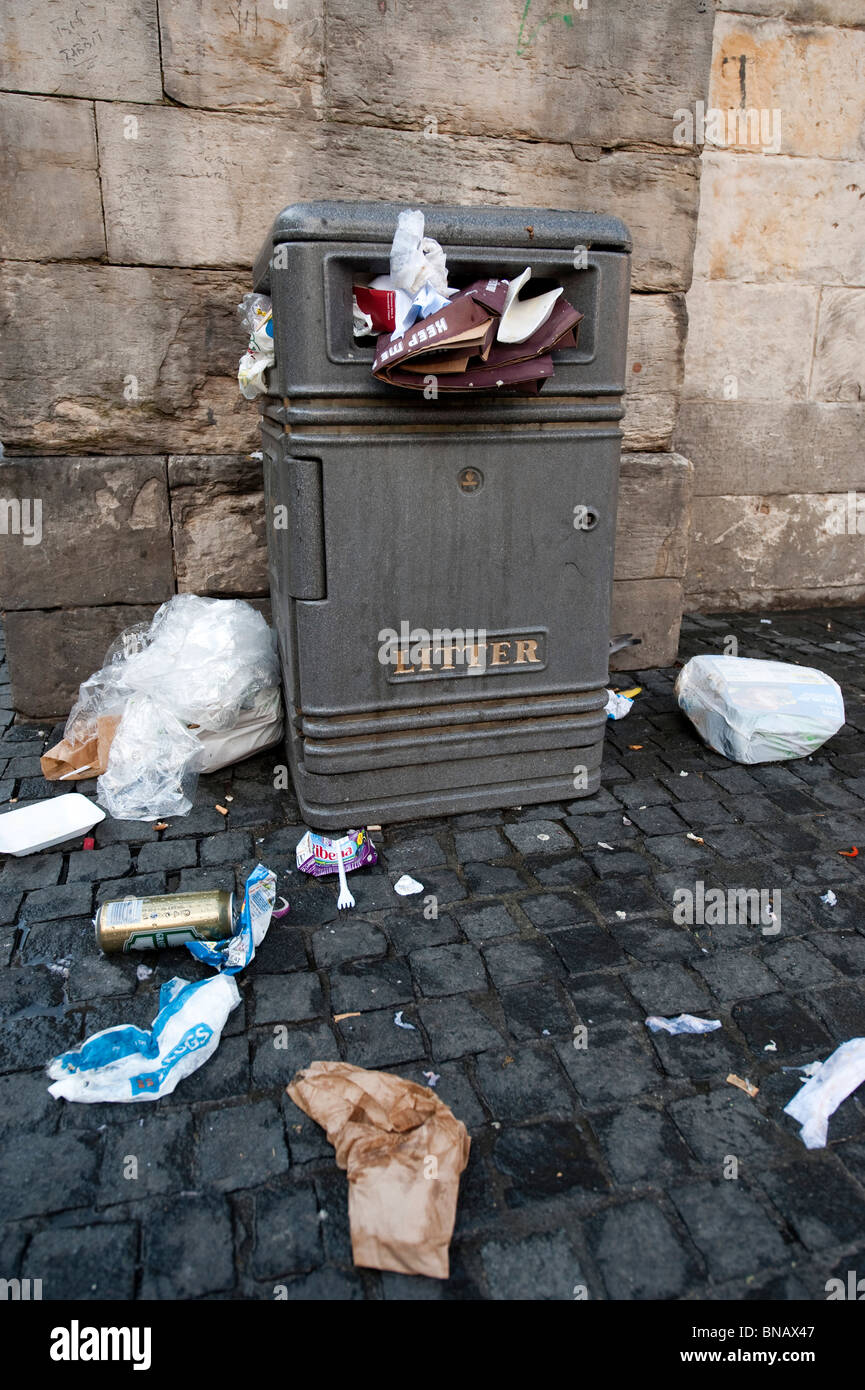 Bin full of of rubbish and litter on the pavement Stock Photo Alamy