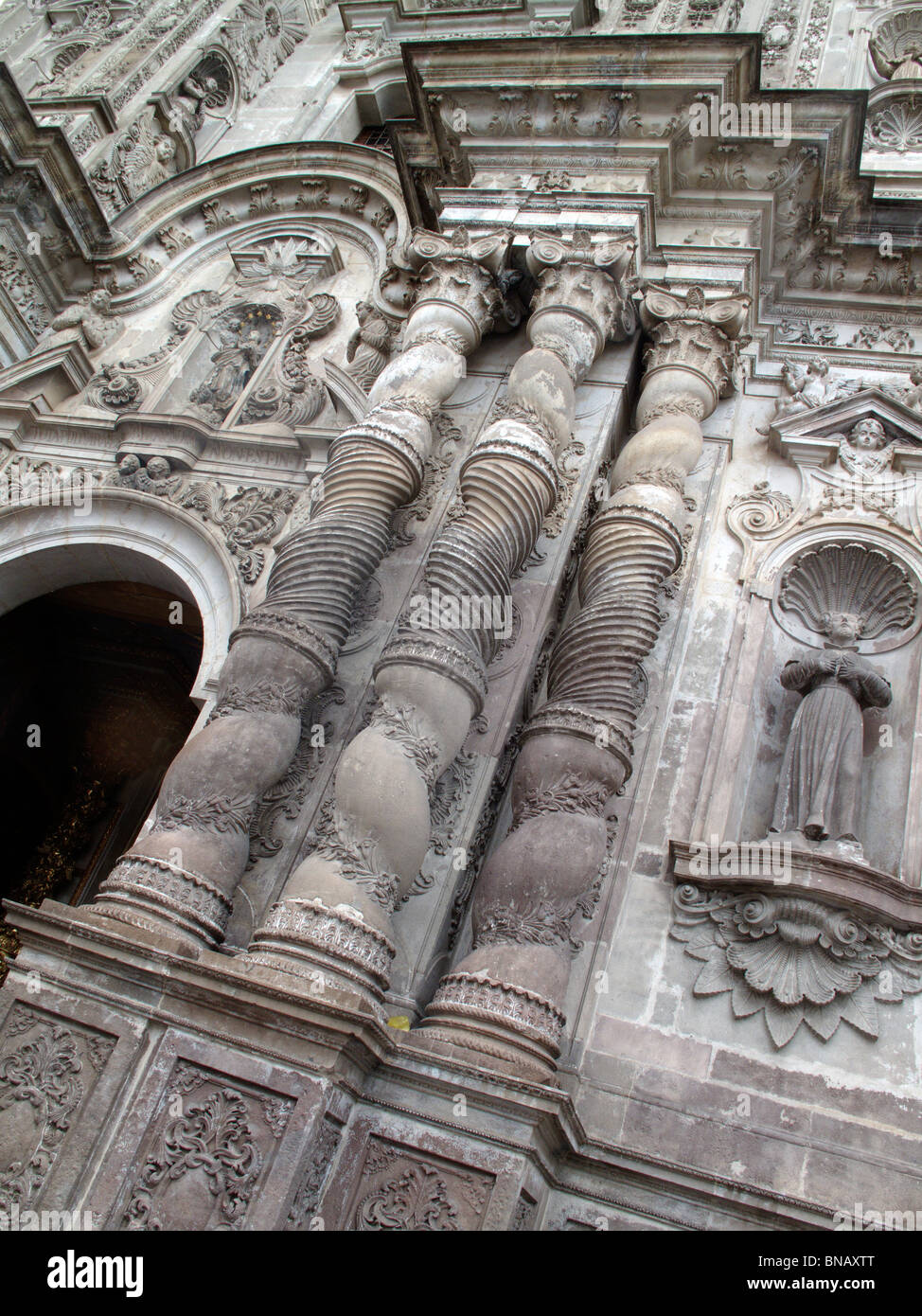 Ornate columns on the outside of a church in Quito in Ecuador Stock Photo