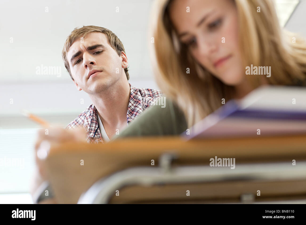 Male high school student copying classmate's work Stock Photo