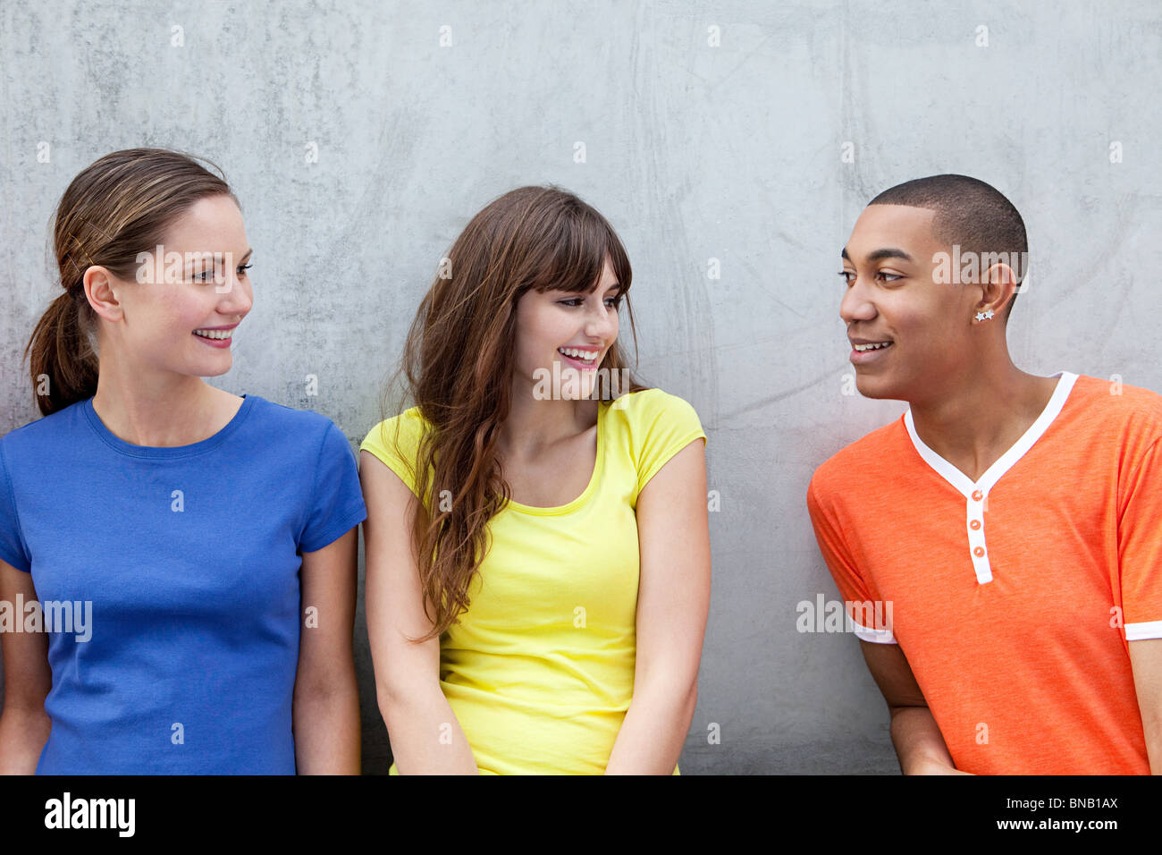 Young man and two young women Stock Photo - Alamy
