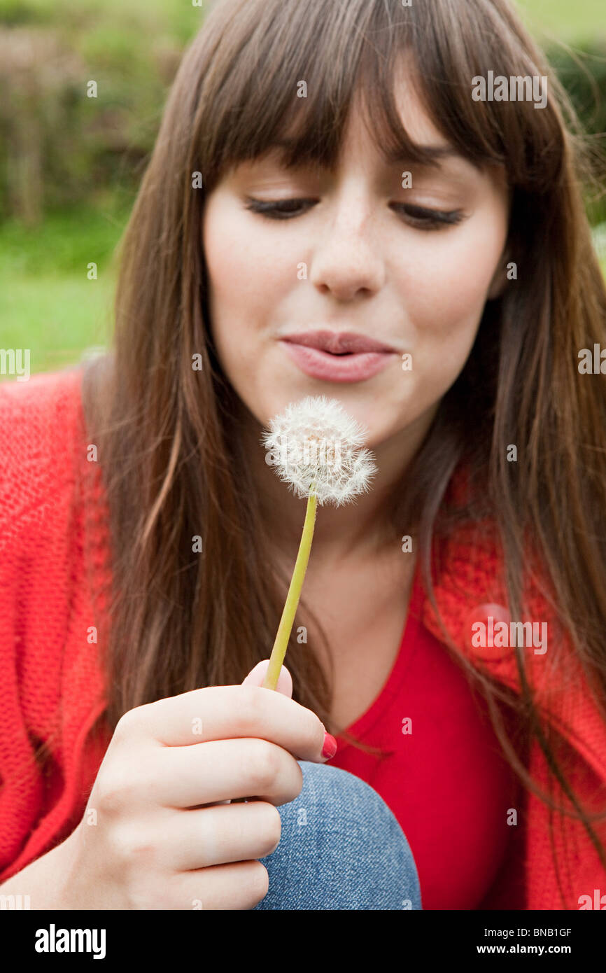 Young woman with dandelion clock Stock Photo Alamy