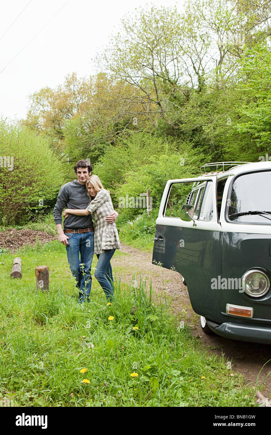 Young couple by camper van Stock Photo