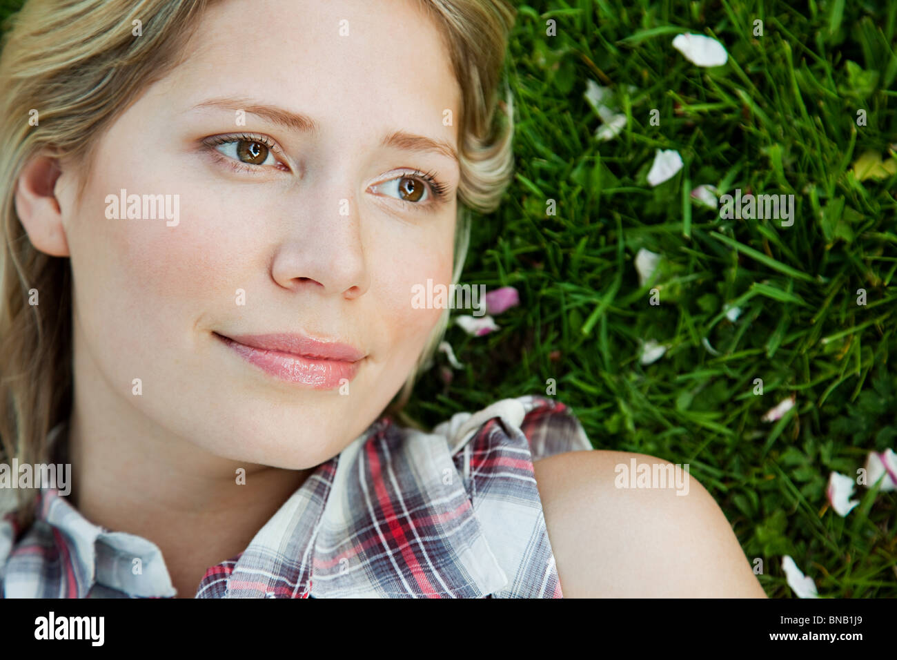 Face of young woman lying on grass Stock Photo Alamy