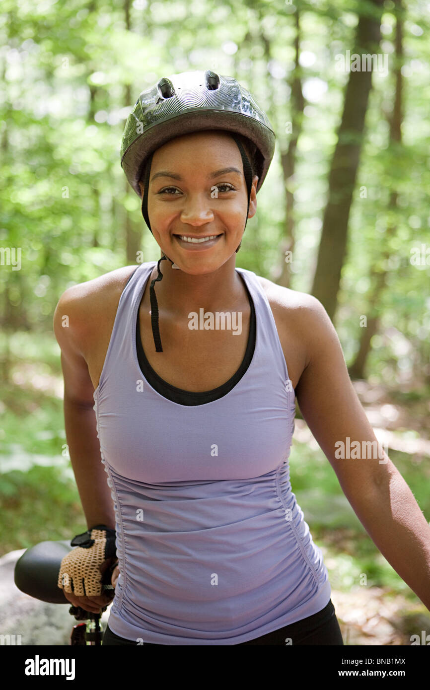 Female cyclist in forest Stock Photo - Alamy