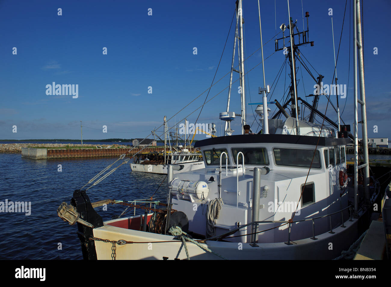 Lameque wharf or dock with deep sea fishing boats tied up New Brunswick Stock Photo