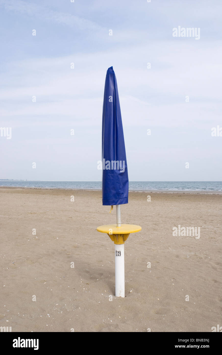 closed sunshade on deserted beach Stock Photo