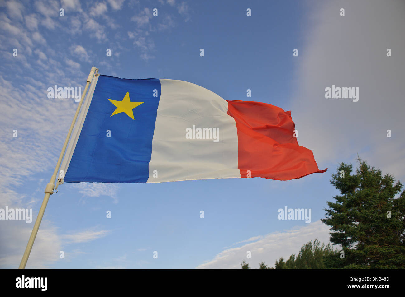 Acadian flag blowing in the breeze in New Brunswick Stock Photo