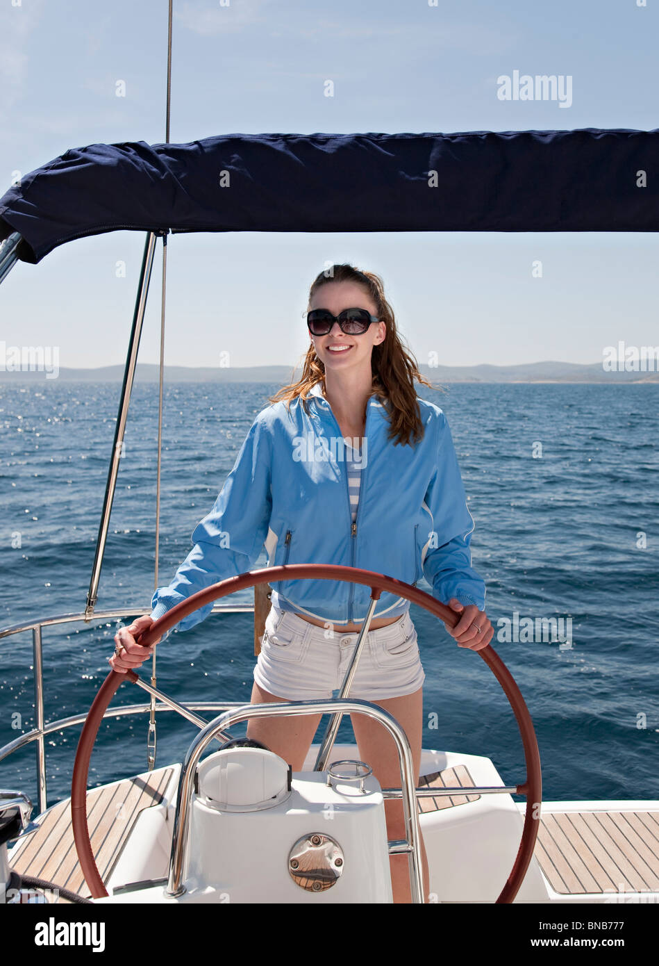 Woman steering yacht Stock Photo Alamy
