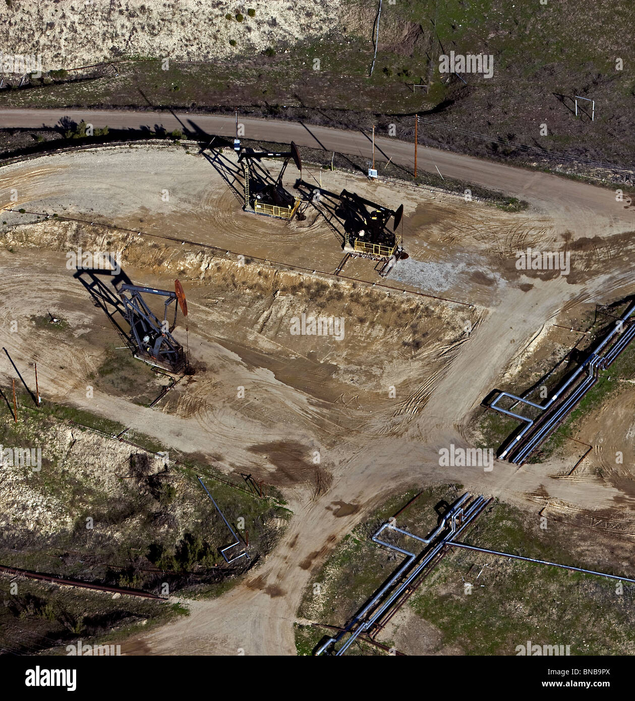 aerial view above oil derricks pipelines San Ardo Oil Field Monterey County central California Stock Photo