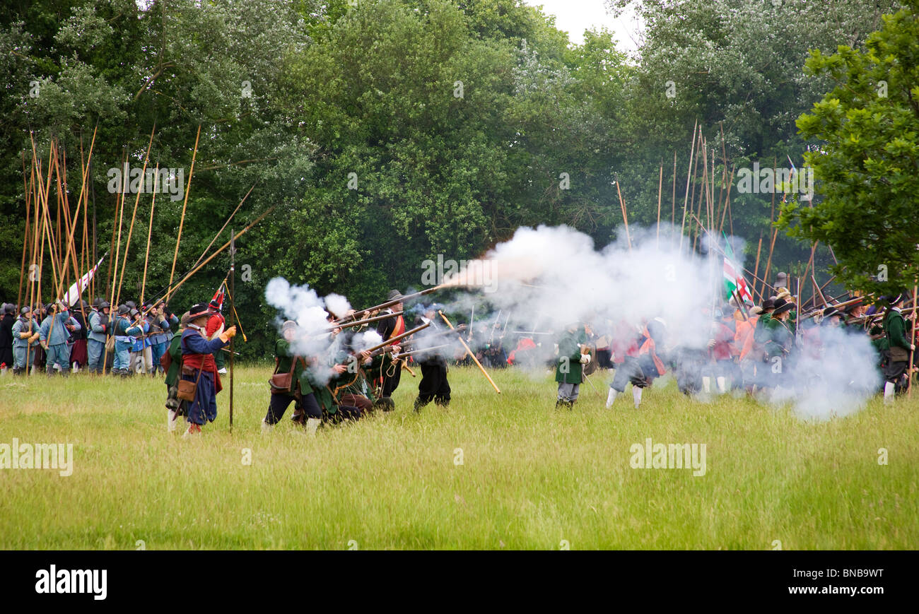 A group of musketeers firing a volley during a skirmish of the Kings Army and the Roundhead Association. Stock Photo