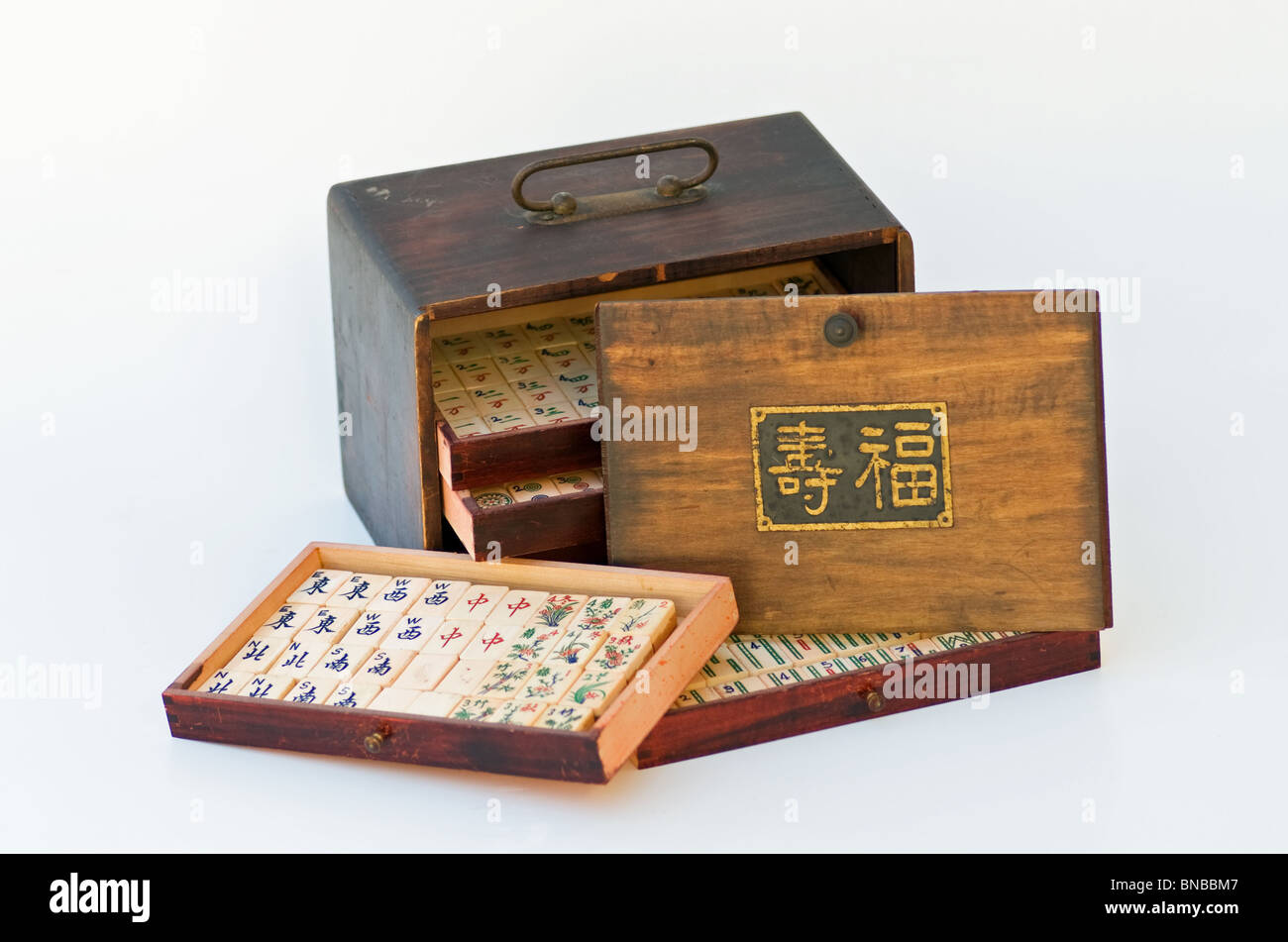 Mah-jong antique game in wood case  with trays of tiles and  longevity sign on the cover. Stock Photo