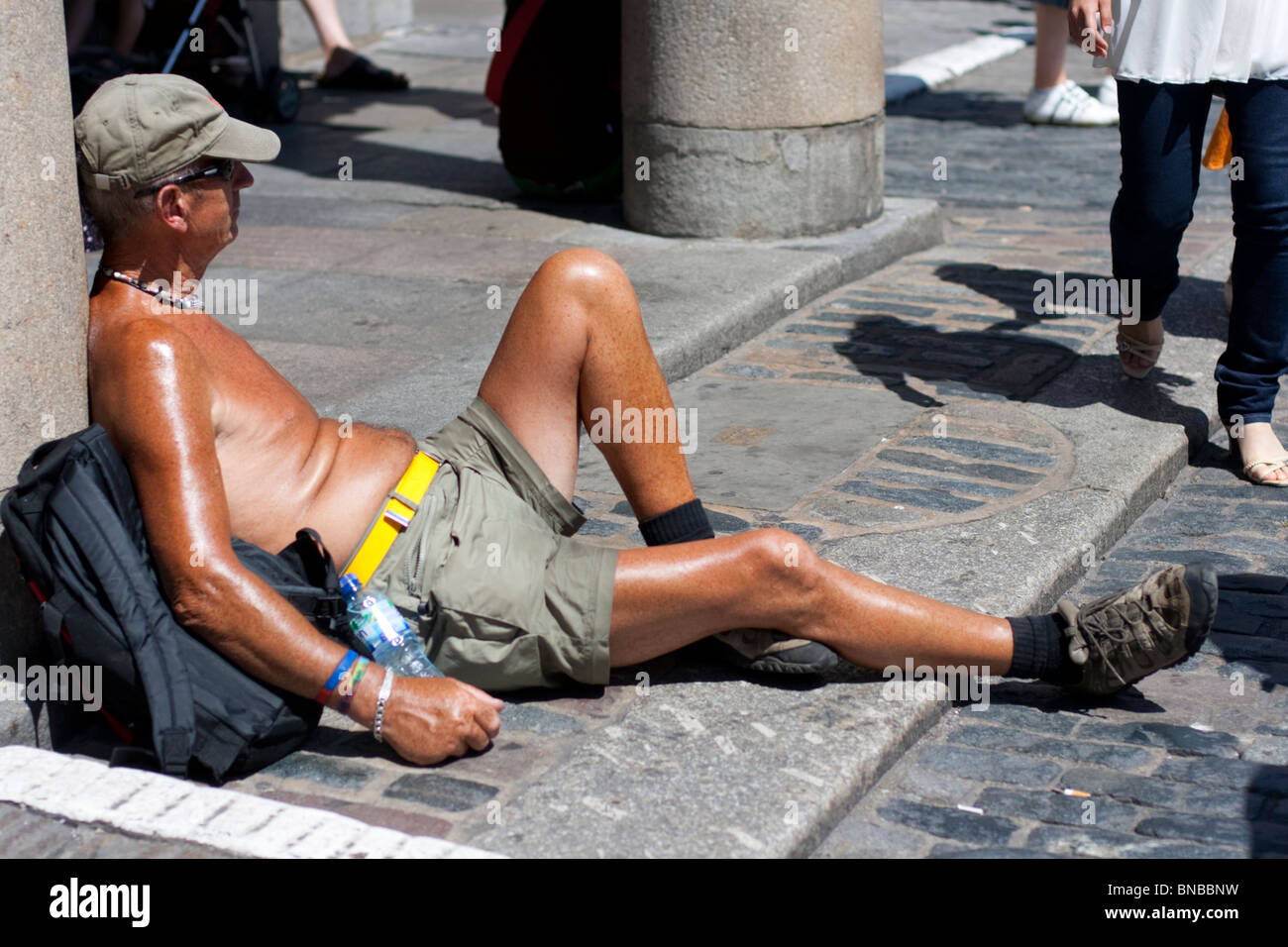 Portrait of suntanned man sunbathing in Covent Garden, London, England, UK Stock Photo