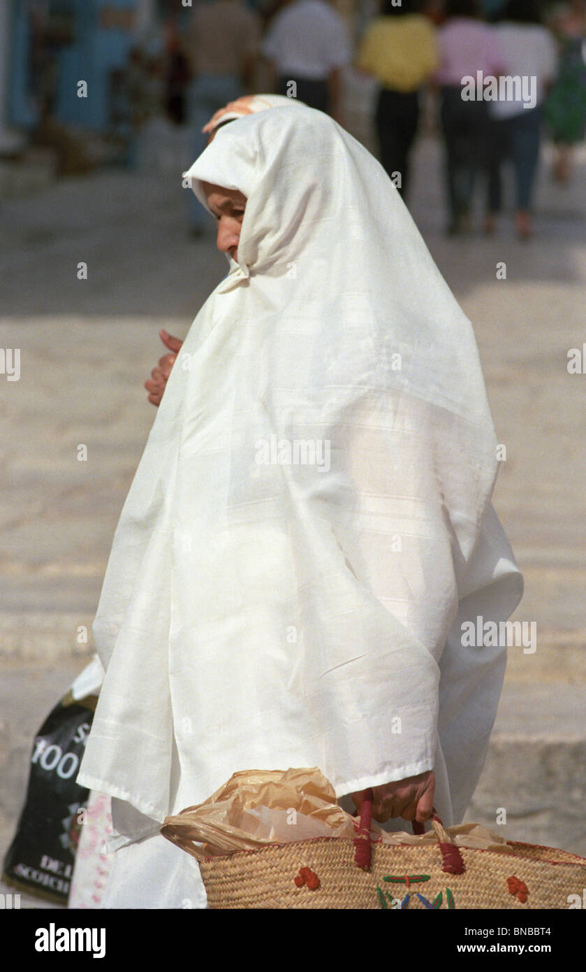 Tunisia, Sidi Bou Said. Woman Wearing Haik, Traditional Female Dress. Stock Photo