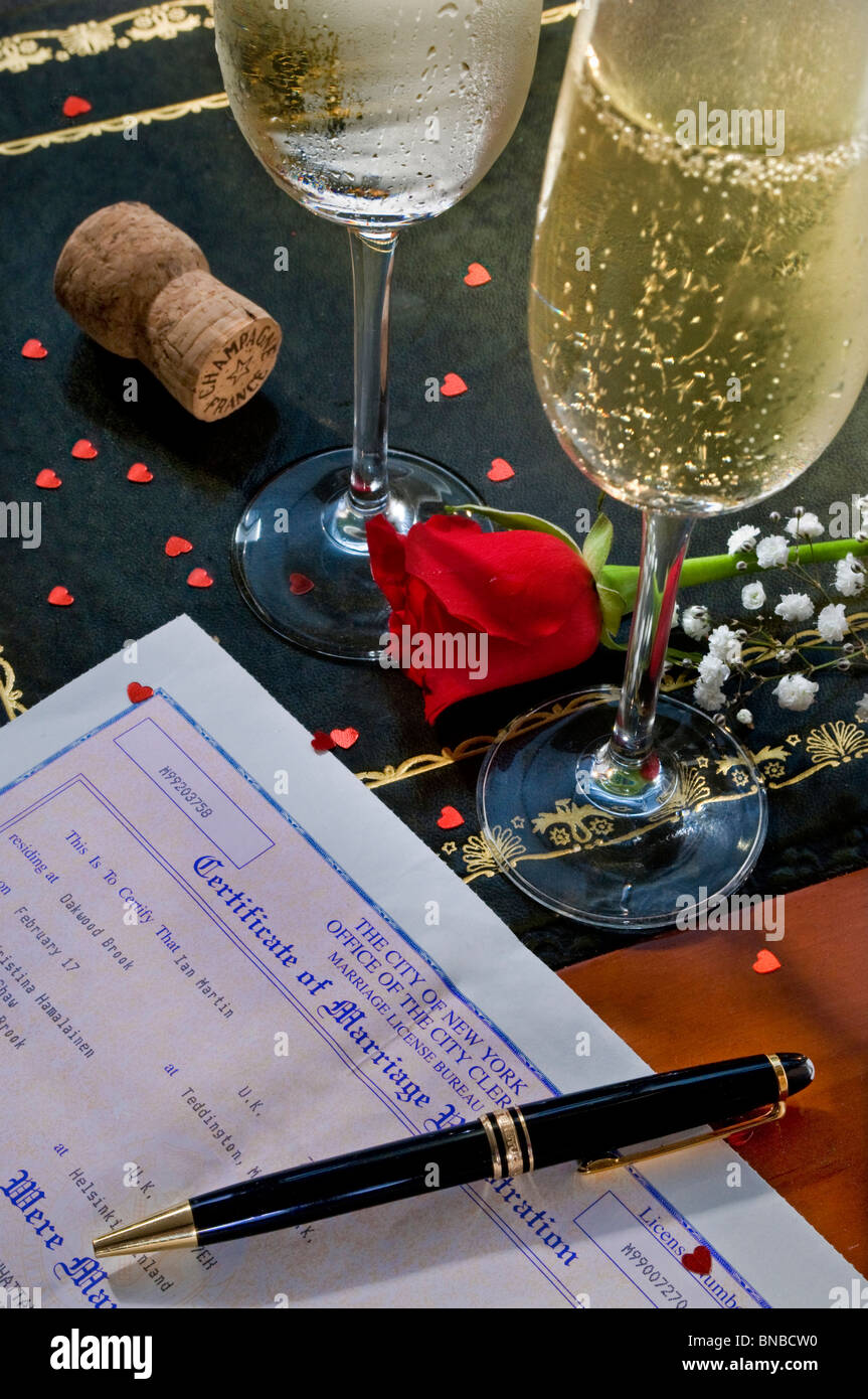 Marriage certificate on desk with red rose and celebration champagne glasses City Hall Manhattan New York USA Stock Photo