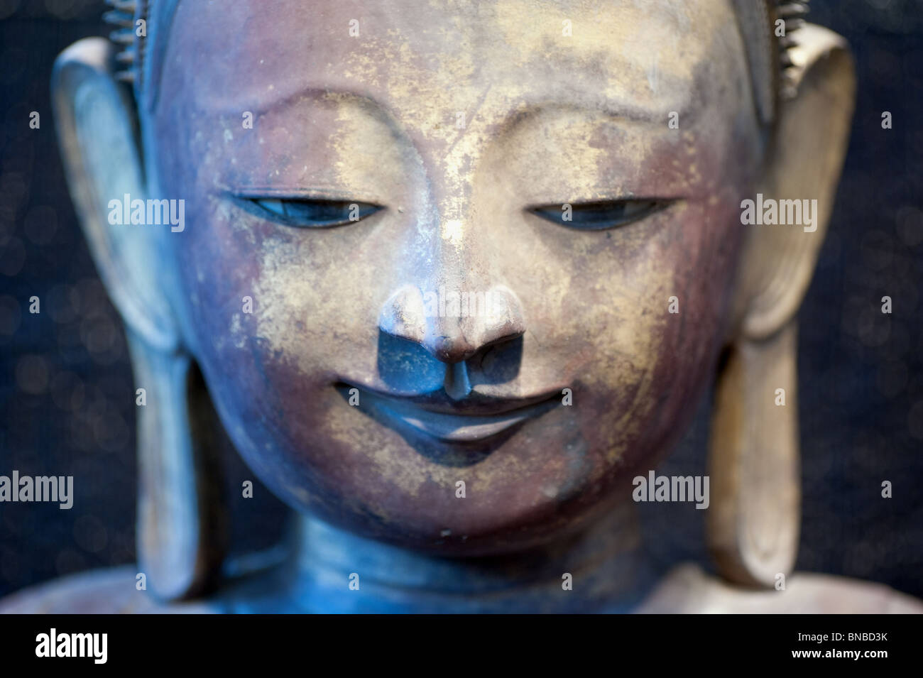 closeup of a buddha bronze staute with his famous elongated ear lobes Stock Photo Alamy