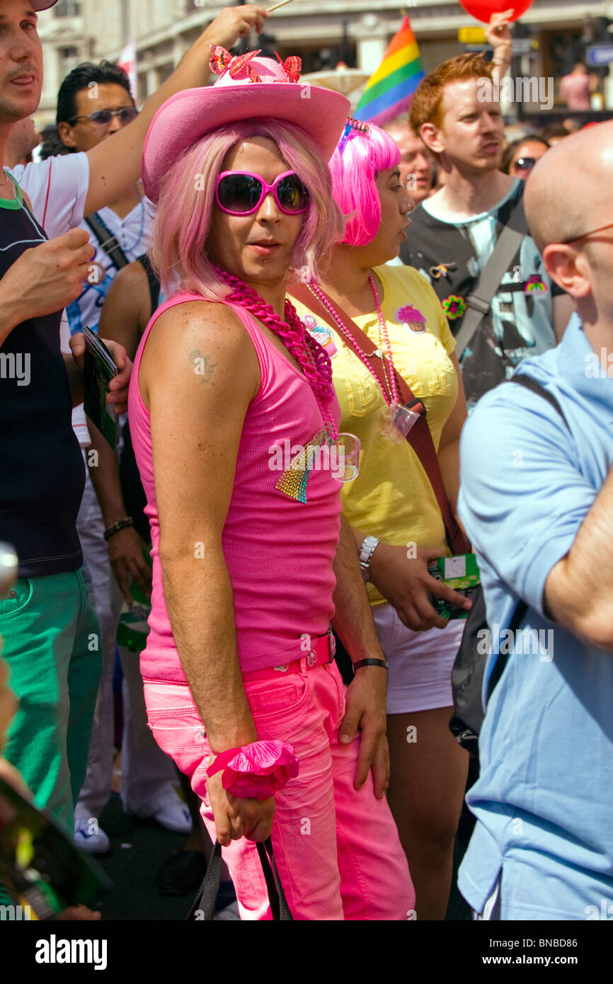 London Gay Pride , pretty in pink , young man or boy poses in pink outfit with stetson cowboy hat with butterflies & sunglasses Stock Photo