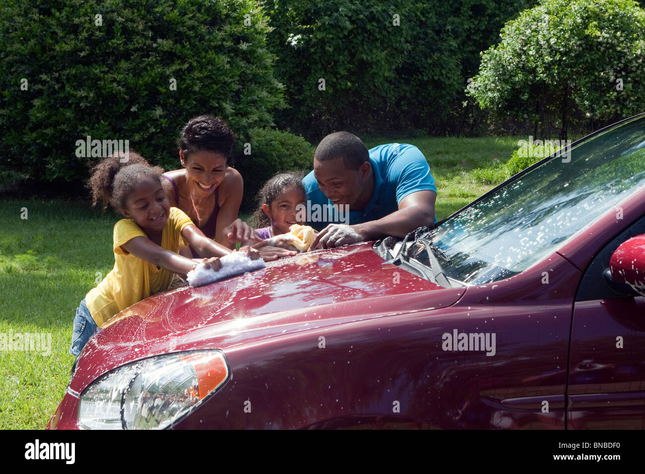 Family washing car and having fun Stock Photo