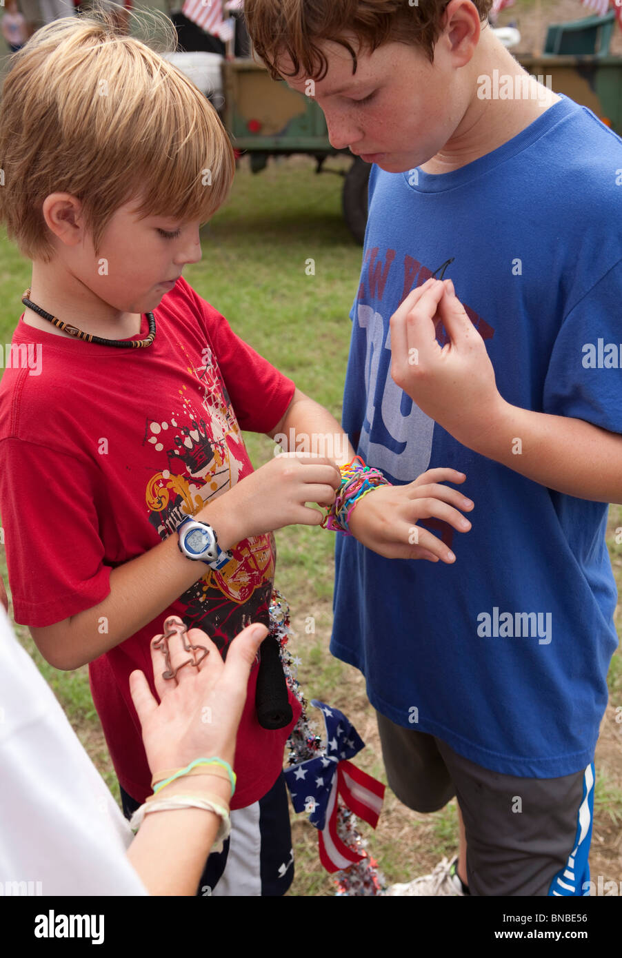 Preteen lsm icdn imgsrc Austin, Texas USA, July 2010: Pre-teen boys trade Silly Bandz at park. ©Bob  Daemmrich Stock Photo - Alamy