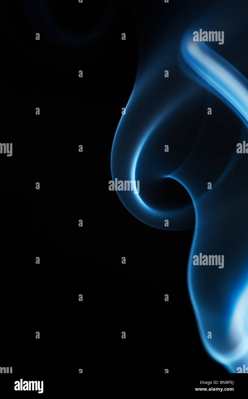 beautiful blue smoke isolated on black background Stock Photo - Alamy