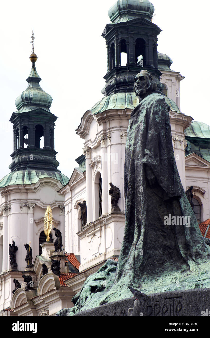 statue of reformer jan hus from prague and church of st. nicholas Stock Photo