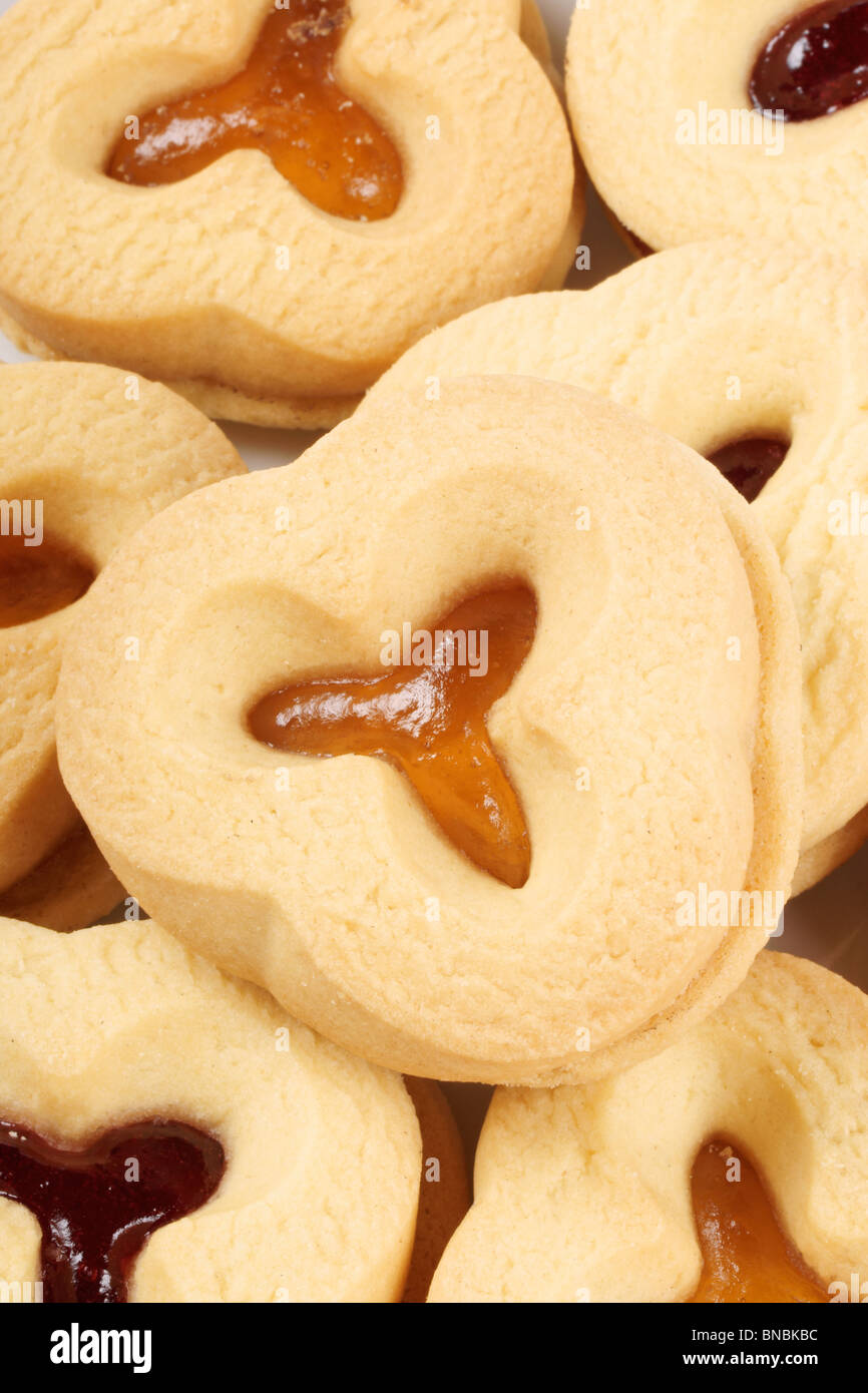 Closeup of some shortcrust pastry biscuits with apricot and plum jam