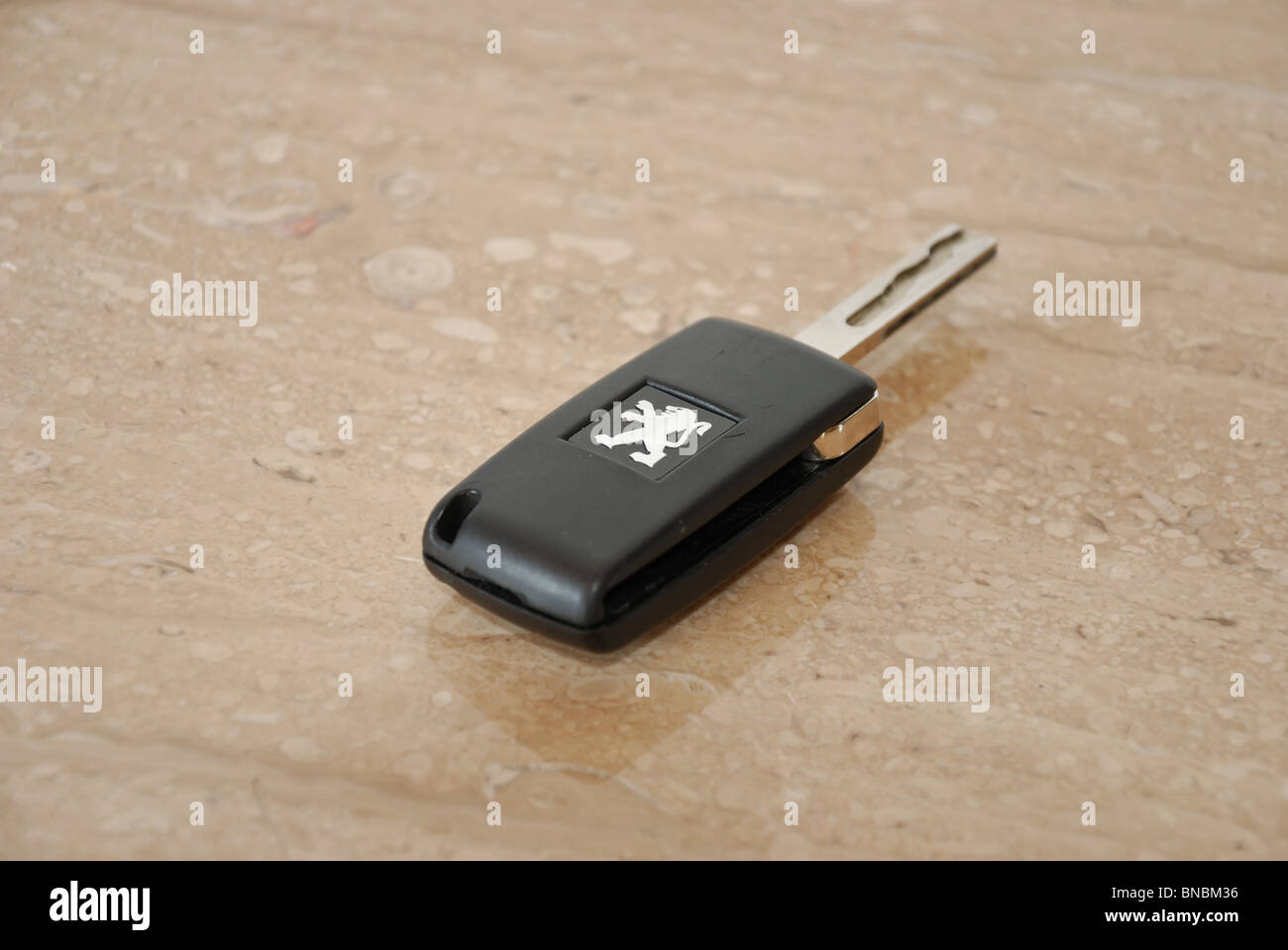 Car keys, car key (Peugeot) with Peugeot logo on marble Stock Photo
