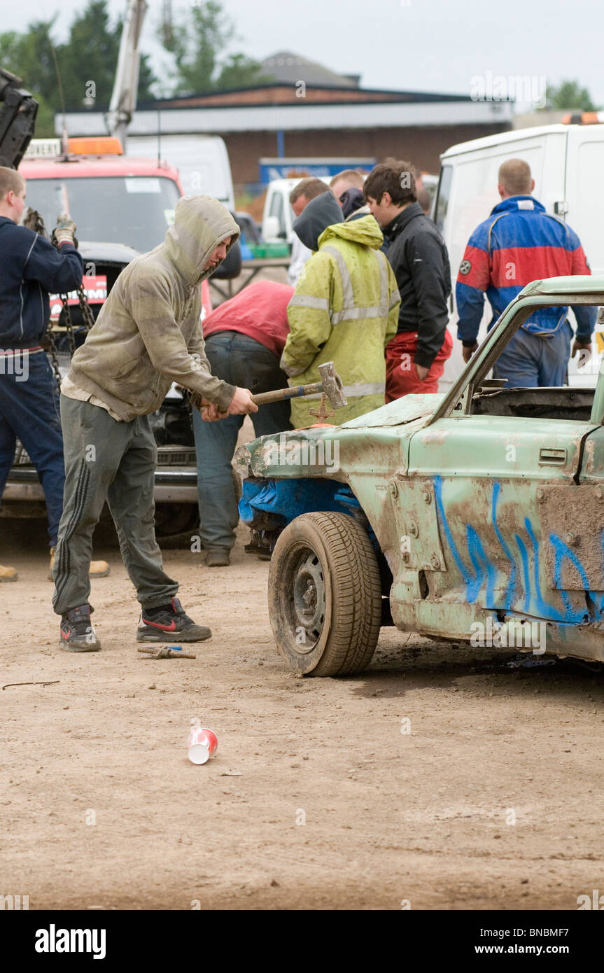 banger racing mechanic driver hitting scrap junk old car with