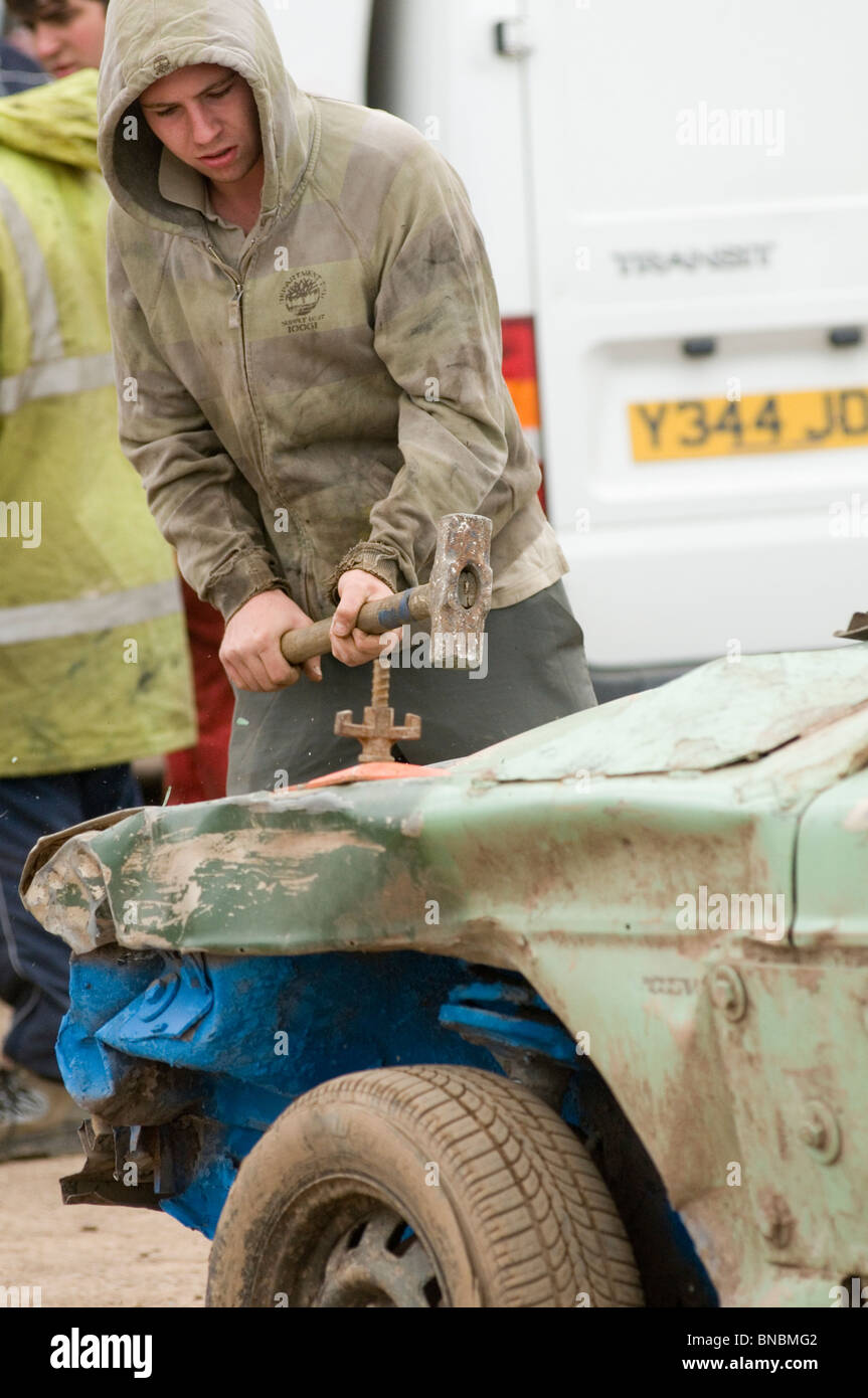 banger racing mechanic driver hitting scrap junk old car with