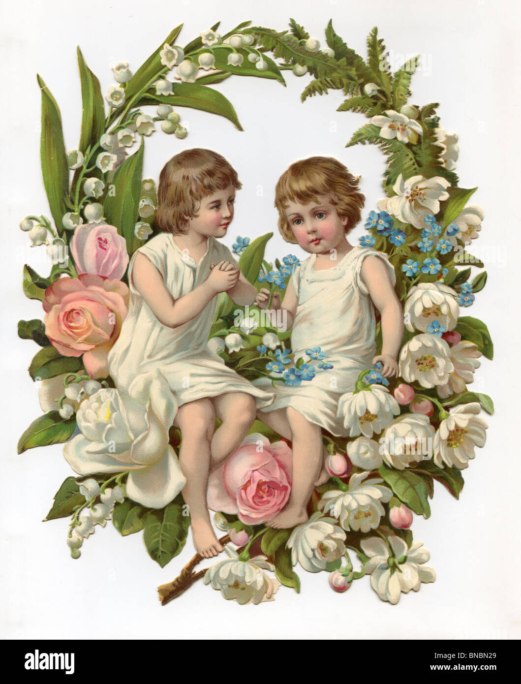 Children sitting on a display of Lily of the Valley, Roses, Forget-Me-Nots and Fern Stock Photo