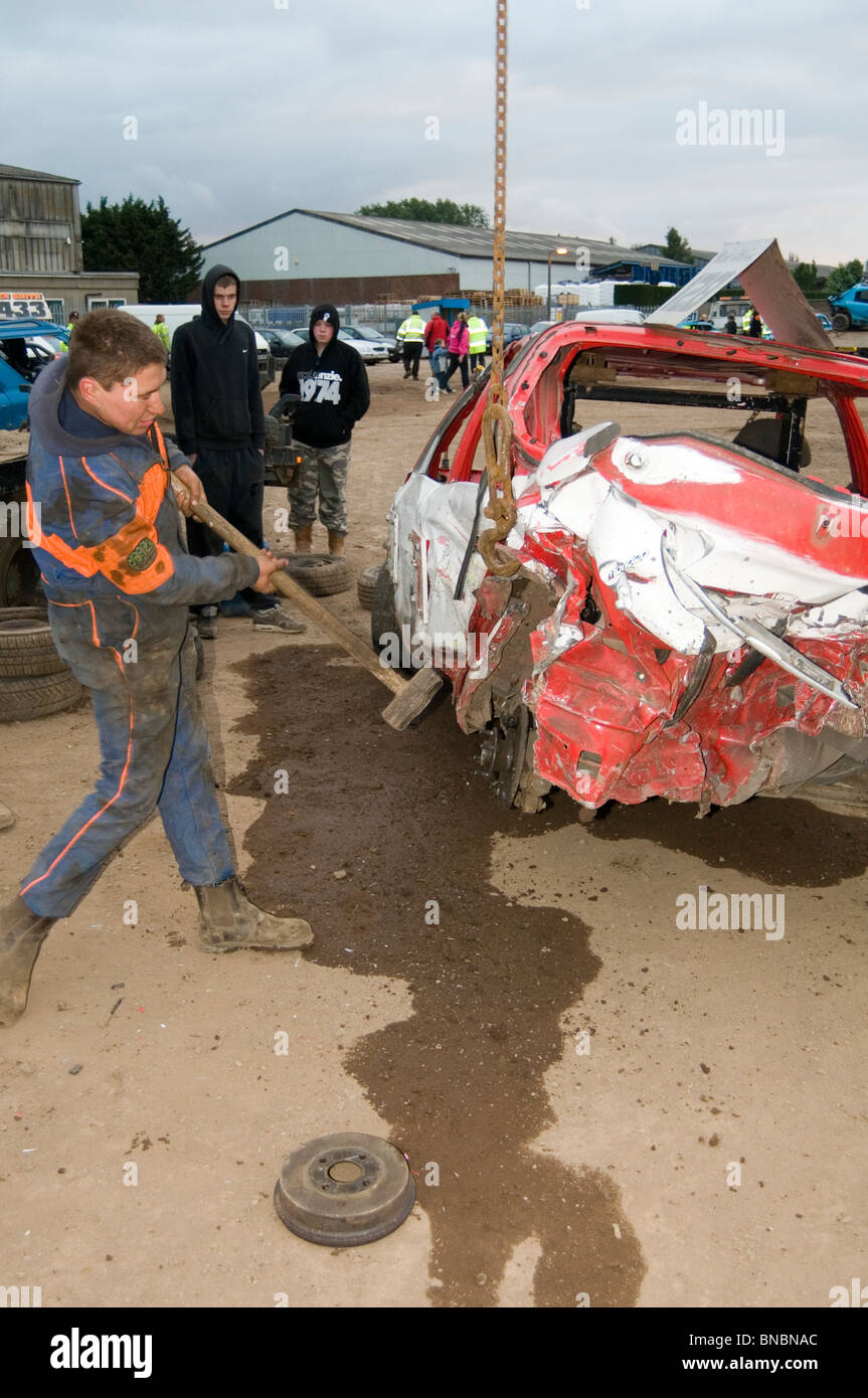 banger racing mechanic driver hitting scrap junk old car with