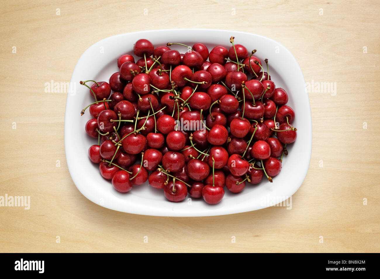 Plate with sweet cherries Stock Photo
