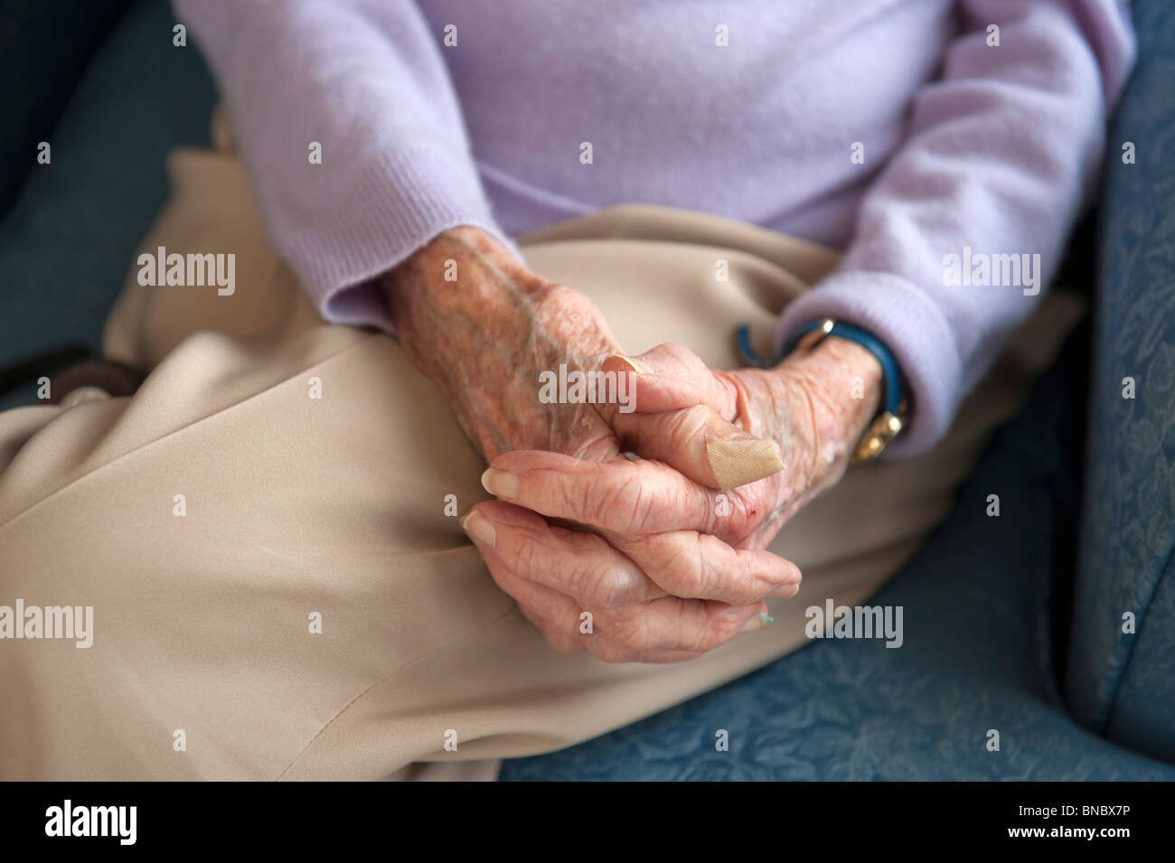 Old womans hands in lap Stock Photo