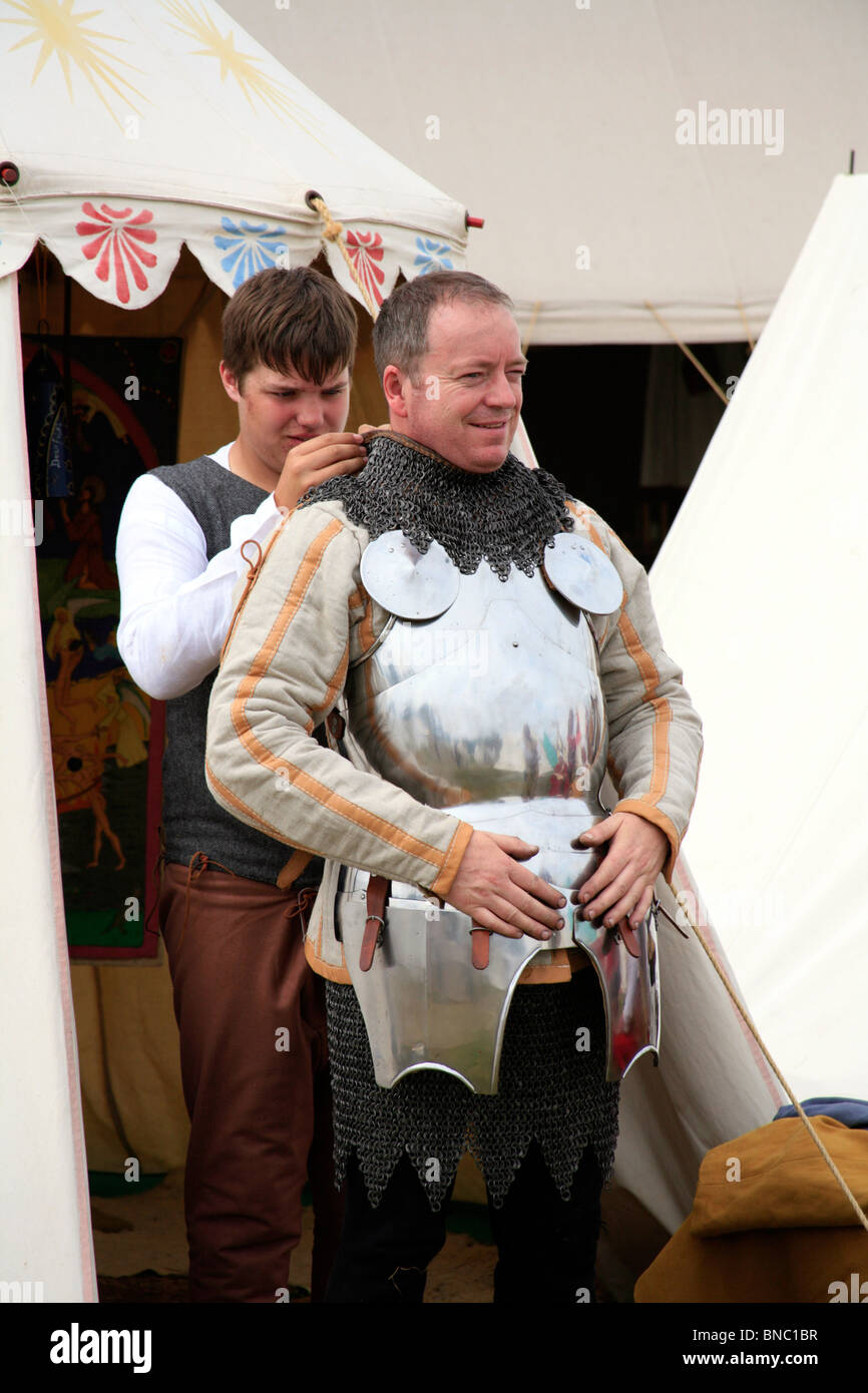 Battle of Tewkesbury Re-enactment, 2010; Medieval knight being suited up in full armour before the battle Stock Photo