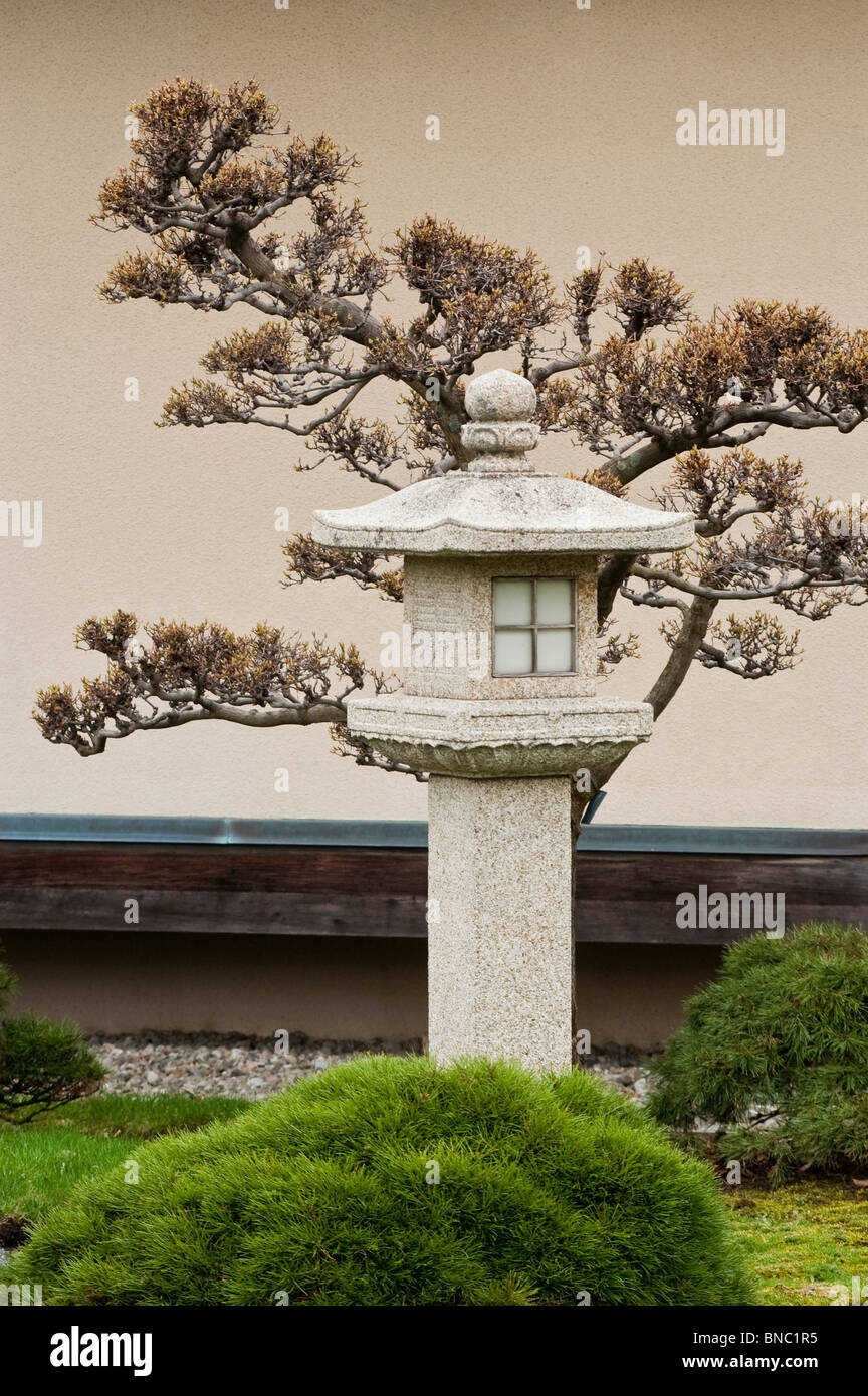 Small tower and bonsai tree, Buddhist Japanese garden in Botanical Garden, Montreal, Canada