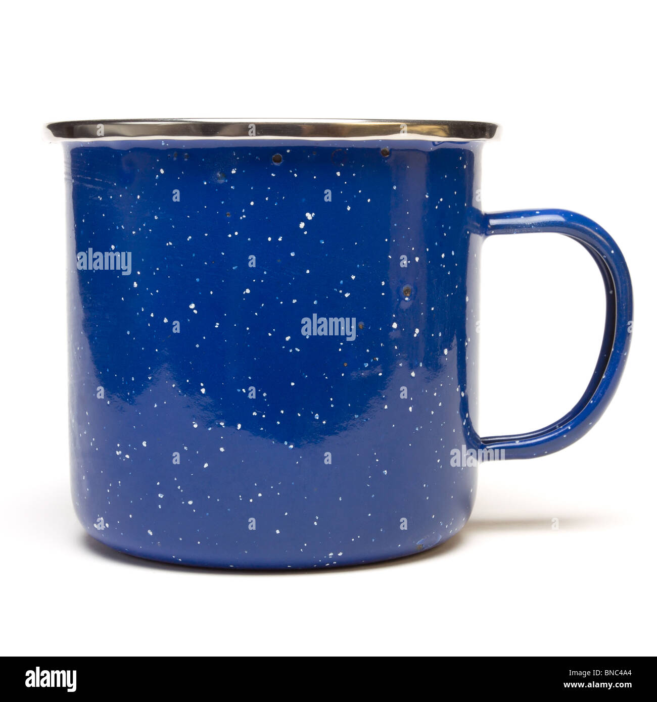 Blue Enamel Tin Cup from low perspective isolated against white background. Stock Photo