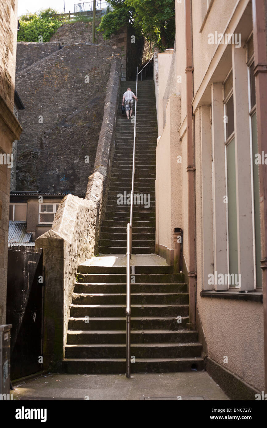 Jacob's Ladder Falmouth. A man climbs with his shopping up Killigrew Street in  which consists of a flight of 111 steps Stock Photo