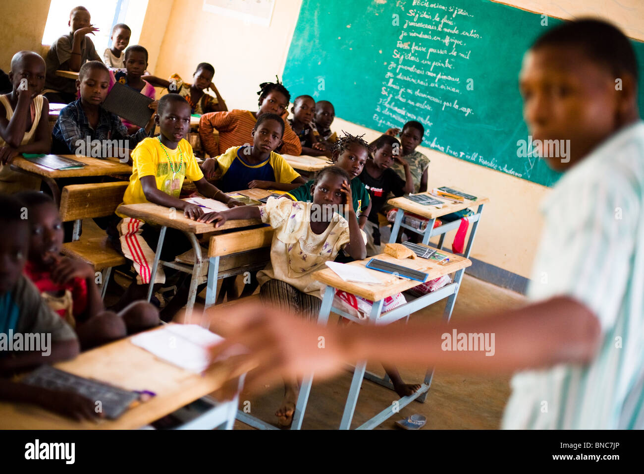 Children listen to their teacher during class at the Youga primary school in the town of Youga. Stock Photo