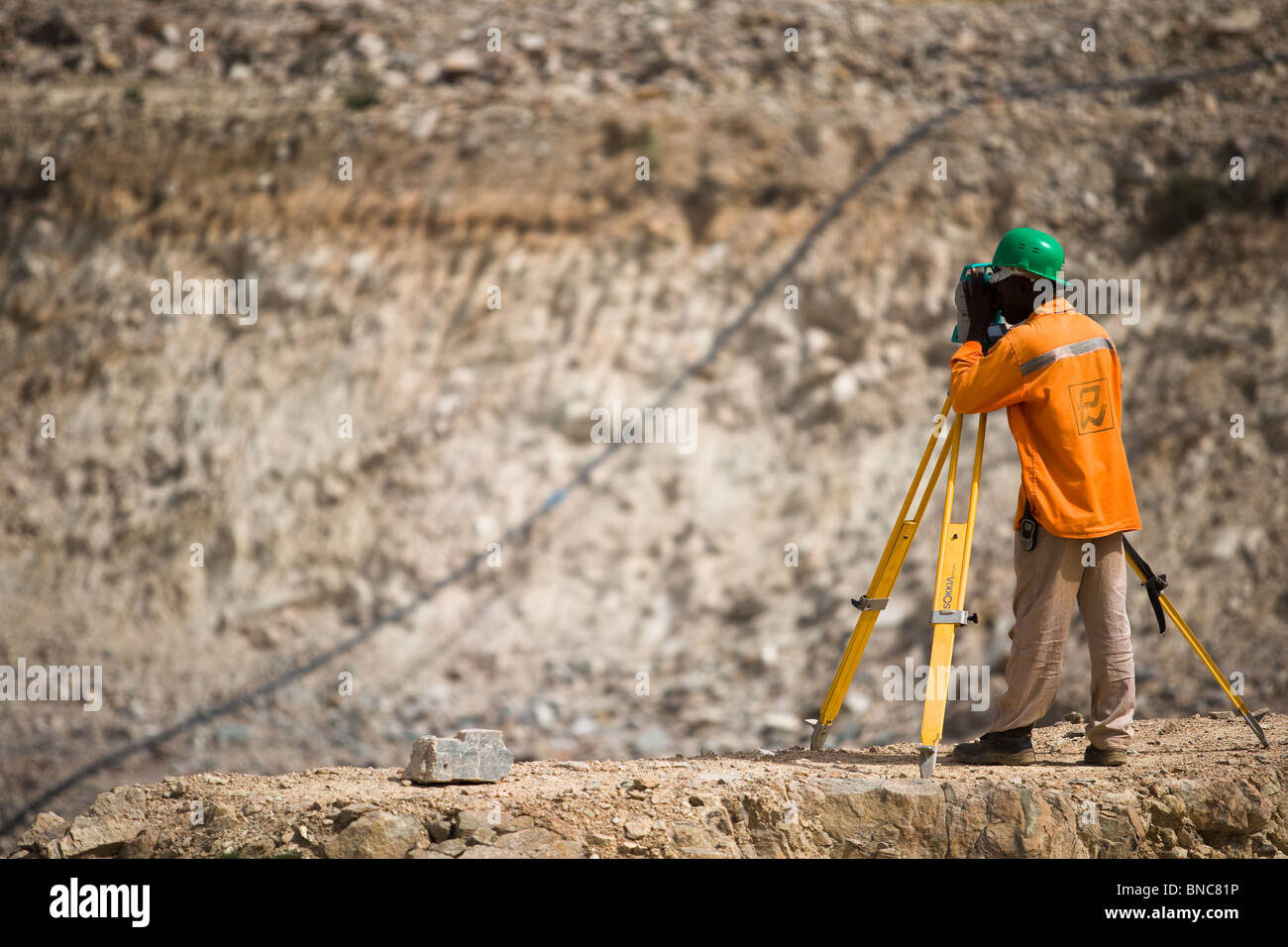 A mine worker surveys at the Youga gold mine near the town of Youga, Burkina Faso. Stock Photo