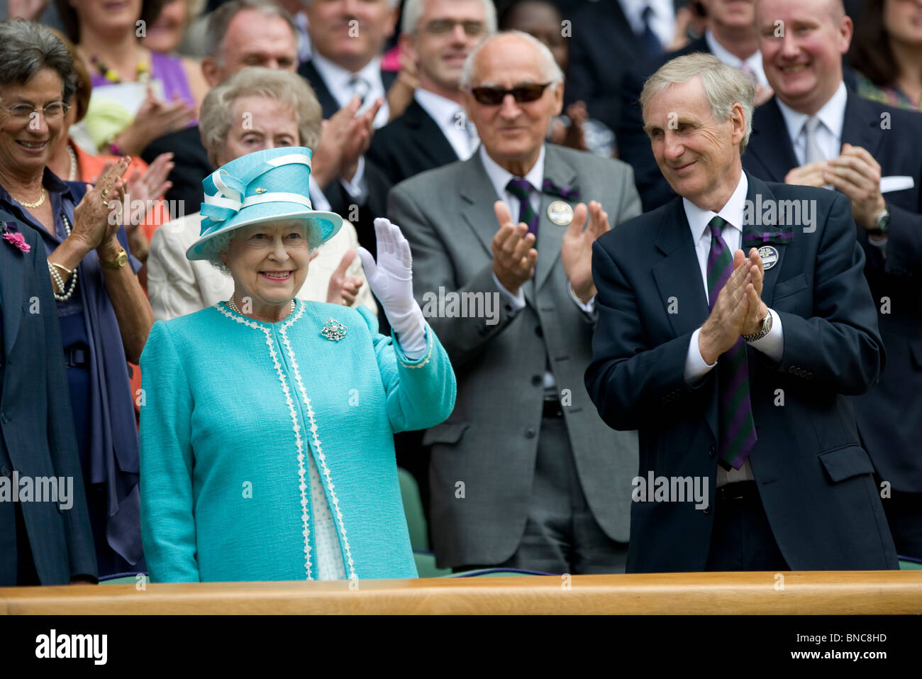 HRH Queen Elizabeth II waves as she arrives in the royal box during the Wimbledon Tennis Championships 2010 Stock Photo