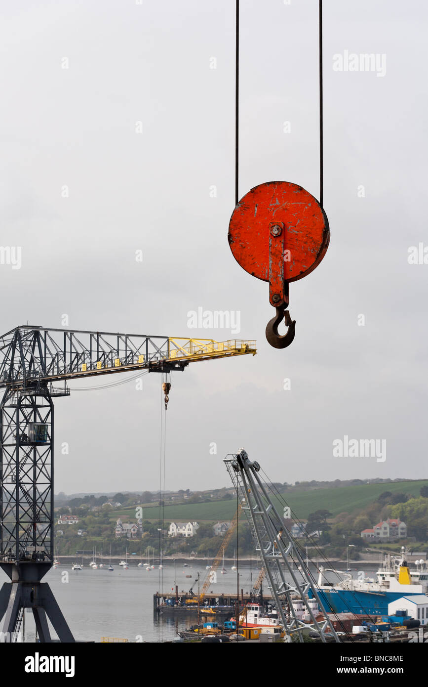 Sky Hook over Falmouth Docks. A huge pully from a large ship building crane  hangs like a sky hook over the busy dry dock Stock Photo - Alamy
