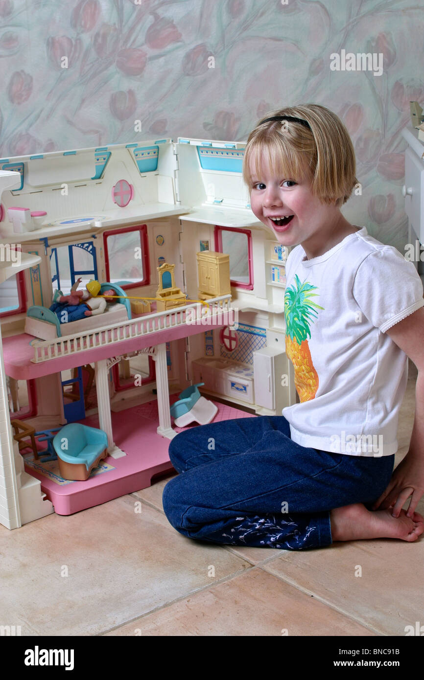 5 year old girl playing with doll house. MR  © Myrleen Pearson Stock Photo