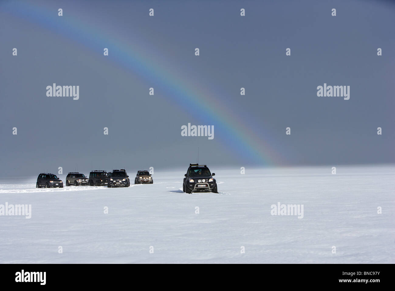 Jeep tour with rainbow on Langjokull Ice Cap, Iceland Stock Photo