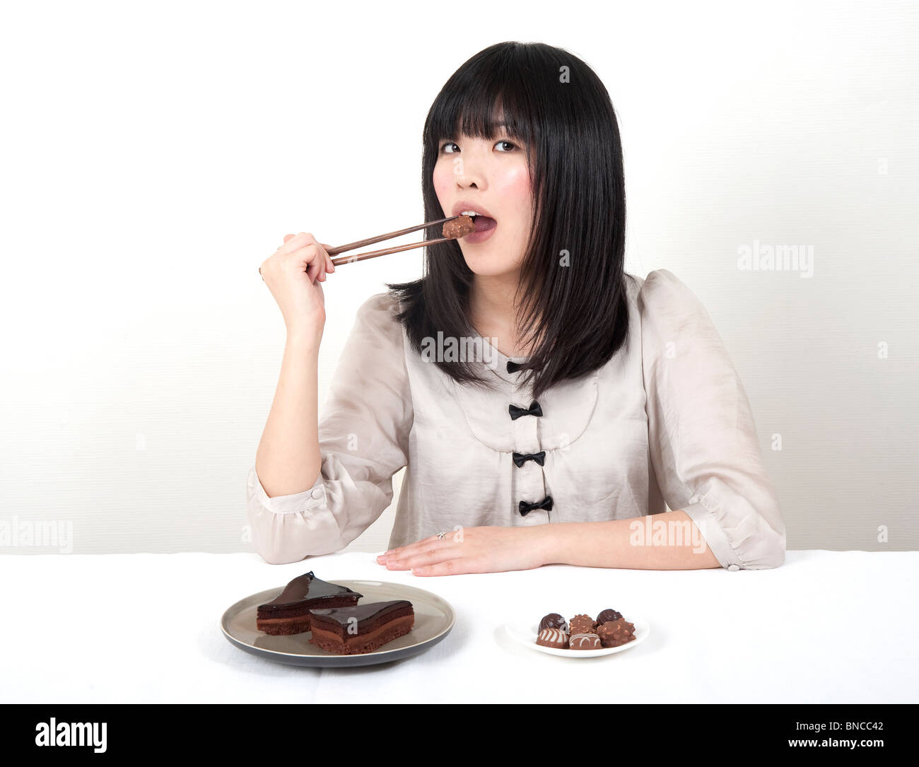 young japanese girl eating chocolate Stock Photo