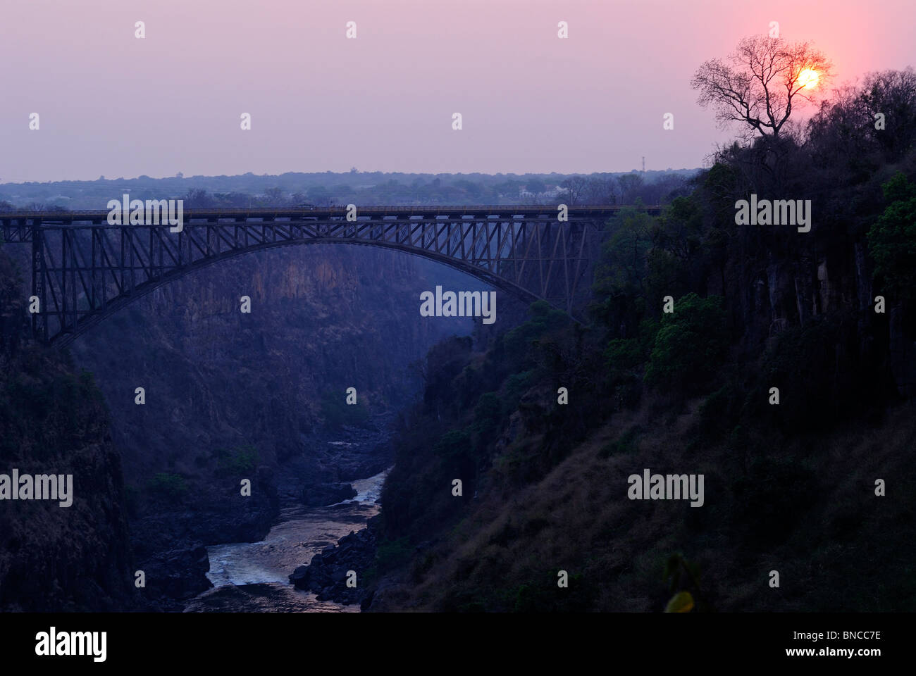 Victoria Falls bridge above the Zambezi River at sunset, Zambia Stock Photo