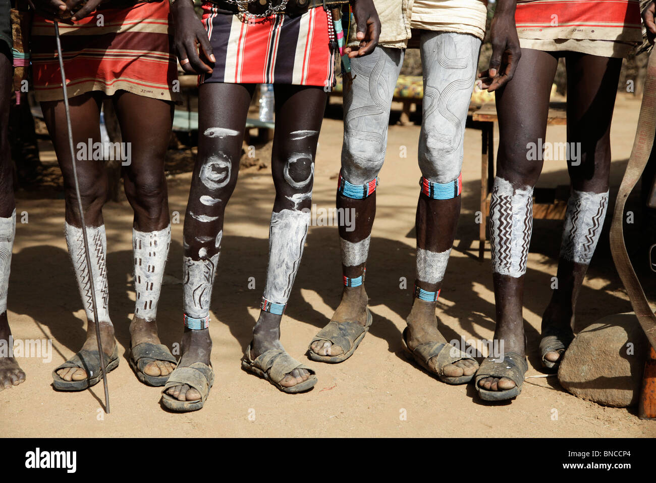 Tsemai men from Southern Ethiopia are showing off their leg body painting Stock Photo