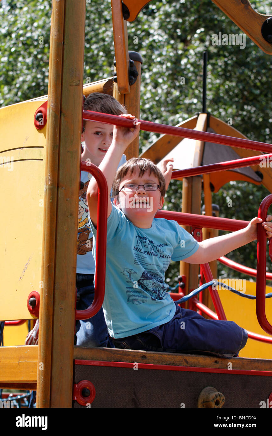 Boys 7 and 8 in the park playing on the climbing apparatus Stock Photo