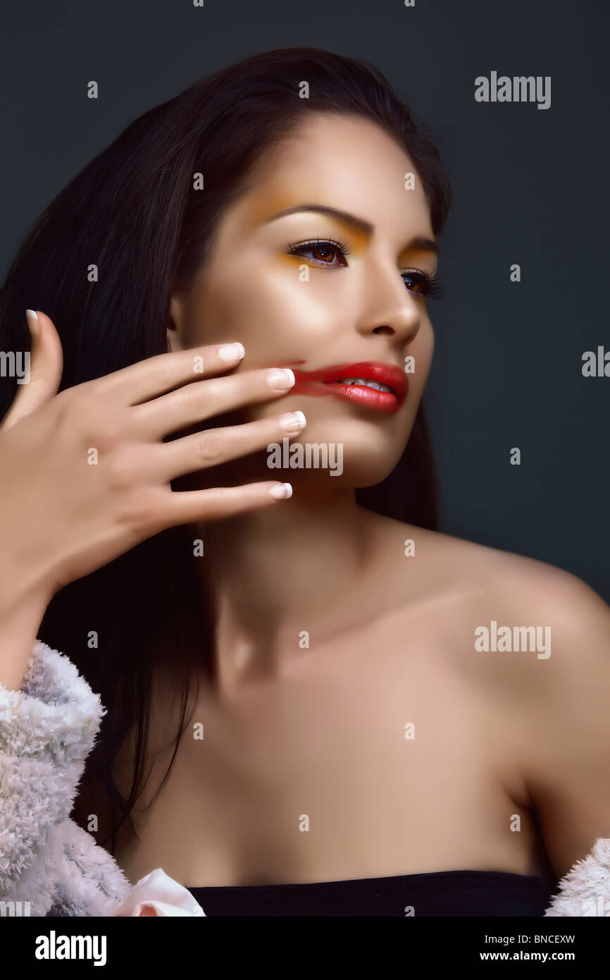 beautiful with long hair removing red lipstick off her face